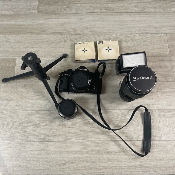 Canon A-1 35mm SLR Film Camera Bundle with Extra lenses Tripod